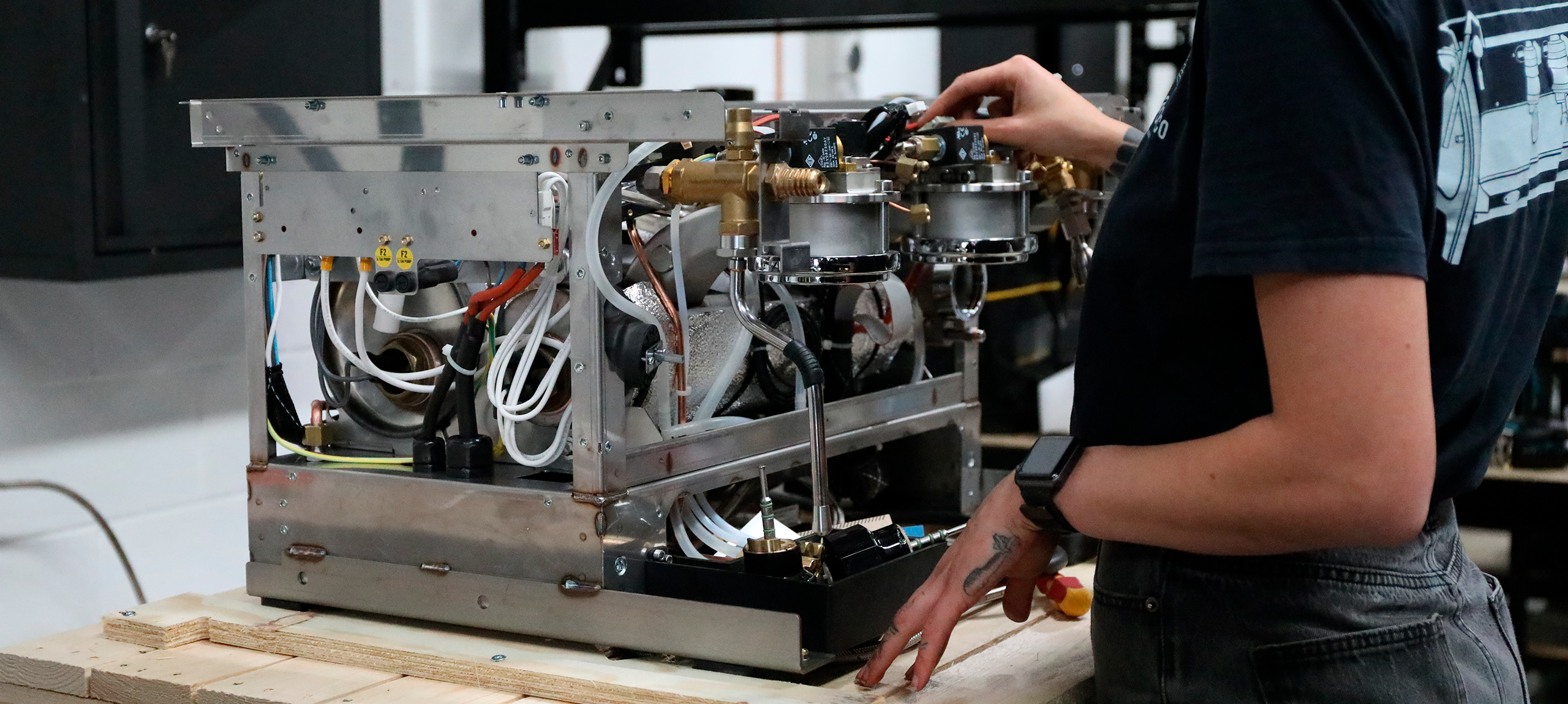 coffee technician repairs the internal workings of a coffee machine